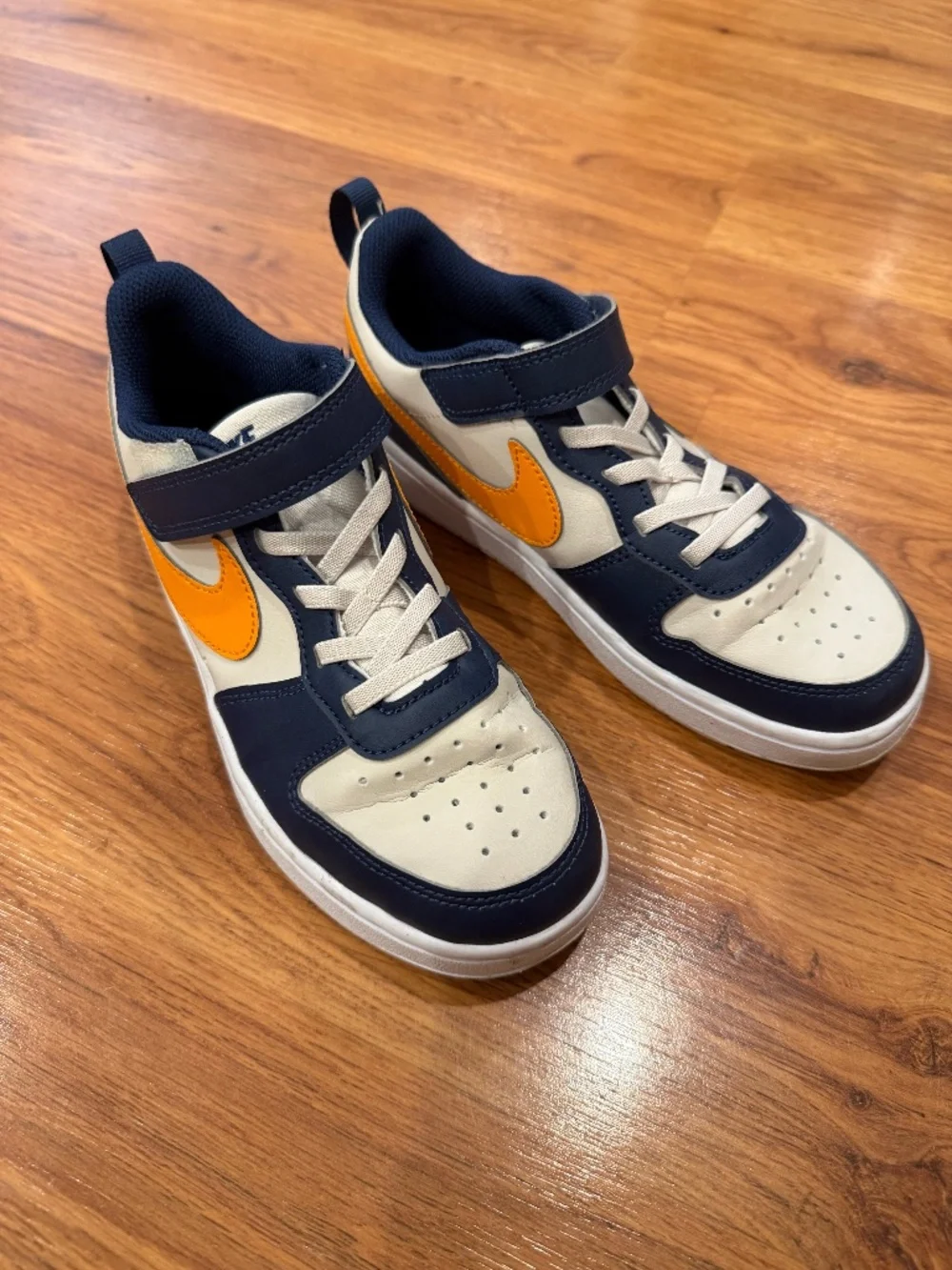 Youth Size 2 Nikes in great condition! navy and yellow